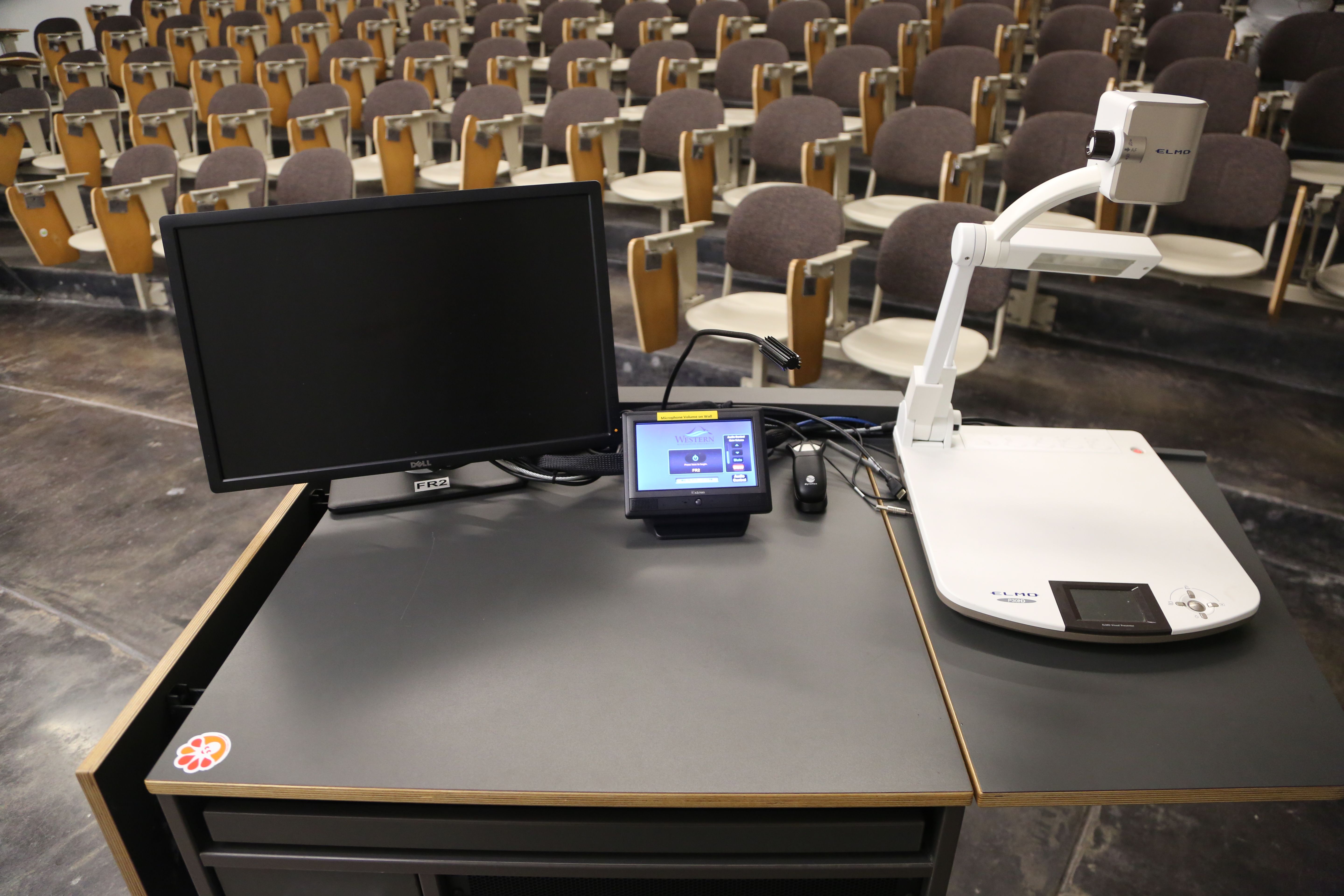Top of the podium has an Elmo document camera, a Dell PC Monitor, and a AV touch screen controller