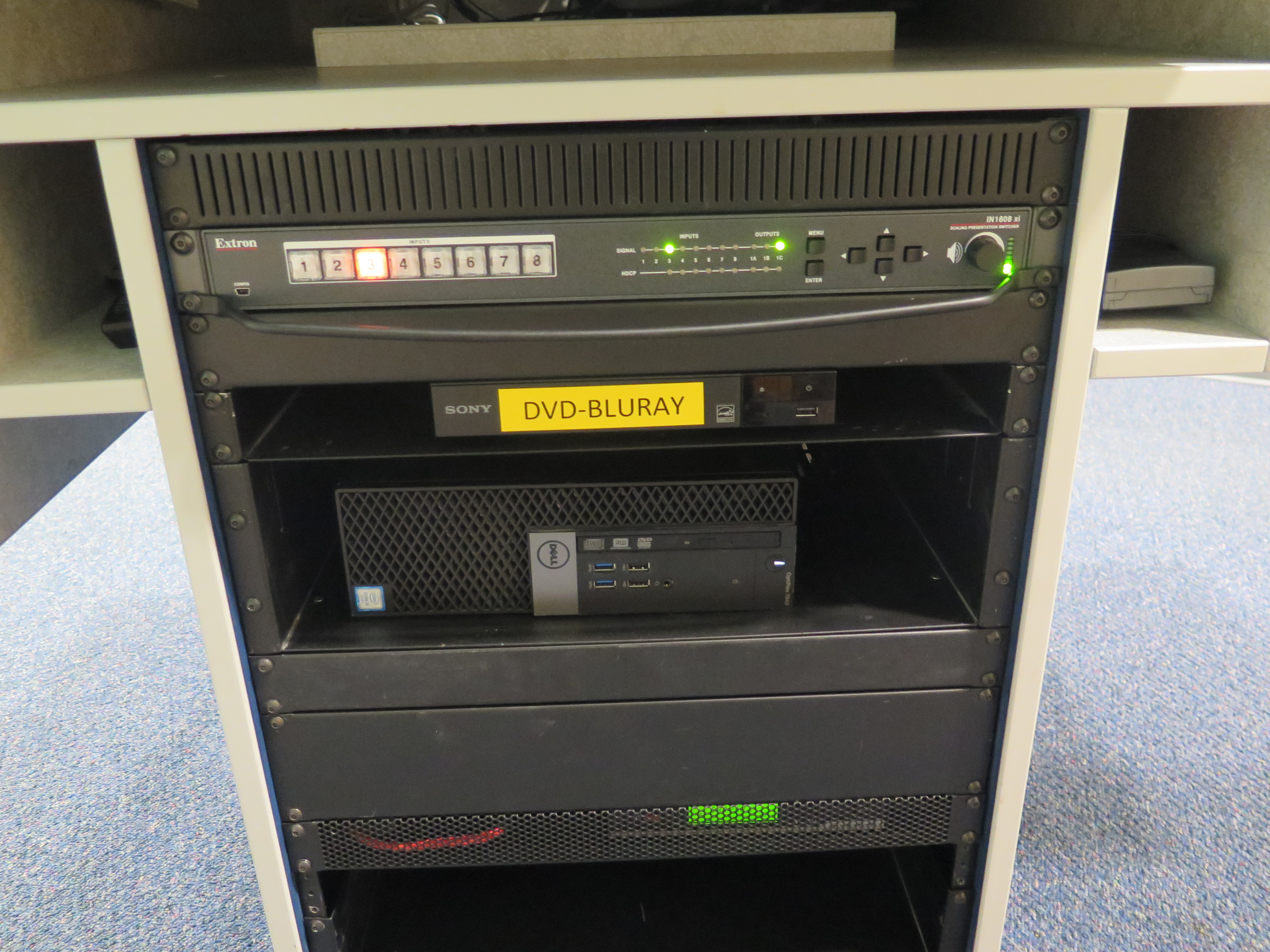 Equipment rack consists of AV Switcher, Blu-Ray/DVD Player and Dell Computer CPU.