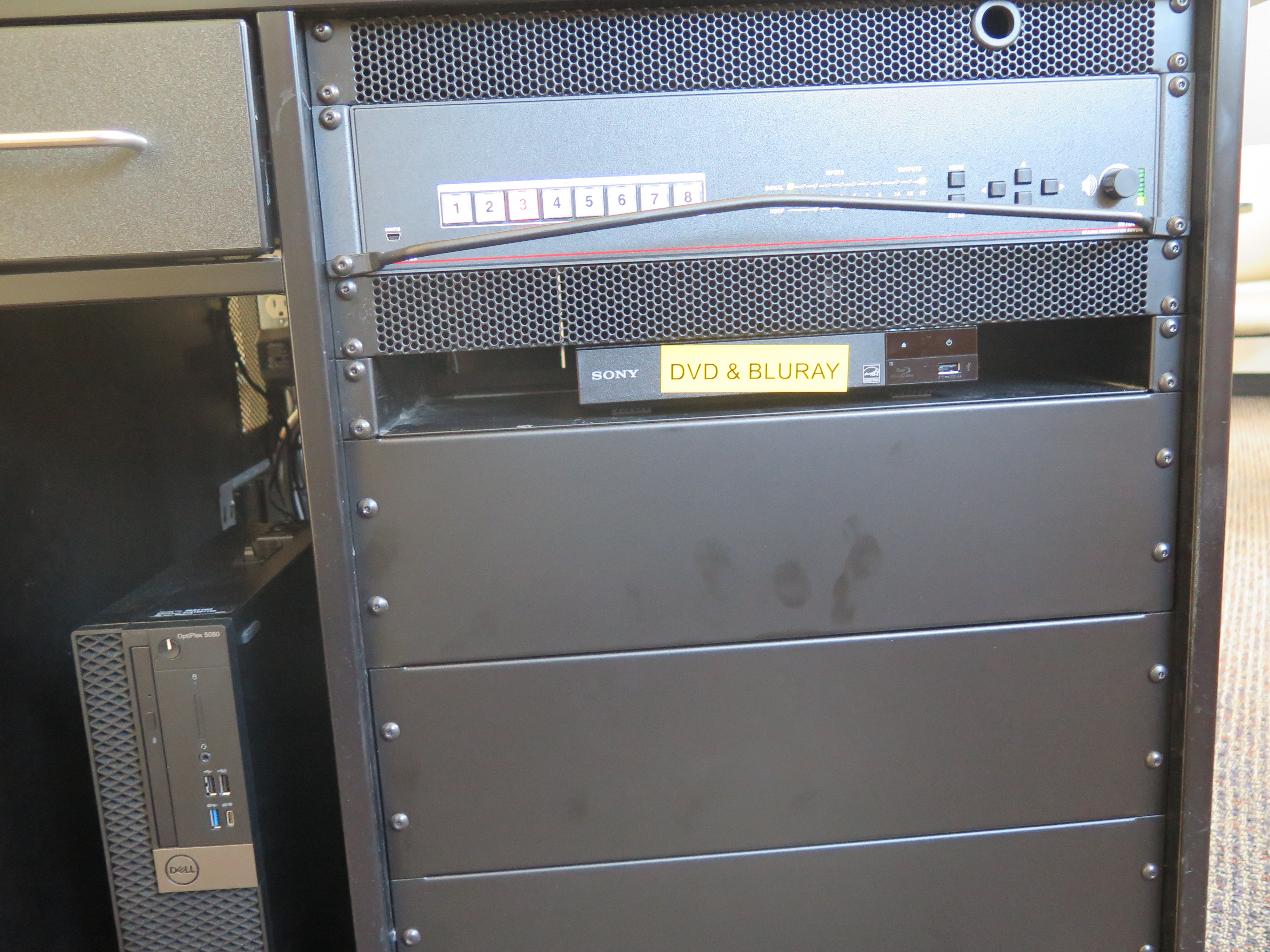 Front of equipment rack showing AV switcher, below that is Blue-Ray/DVD player, to the left is the Dell computer CPU.