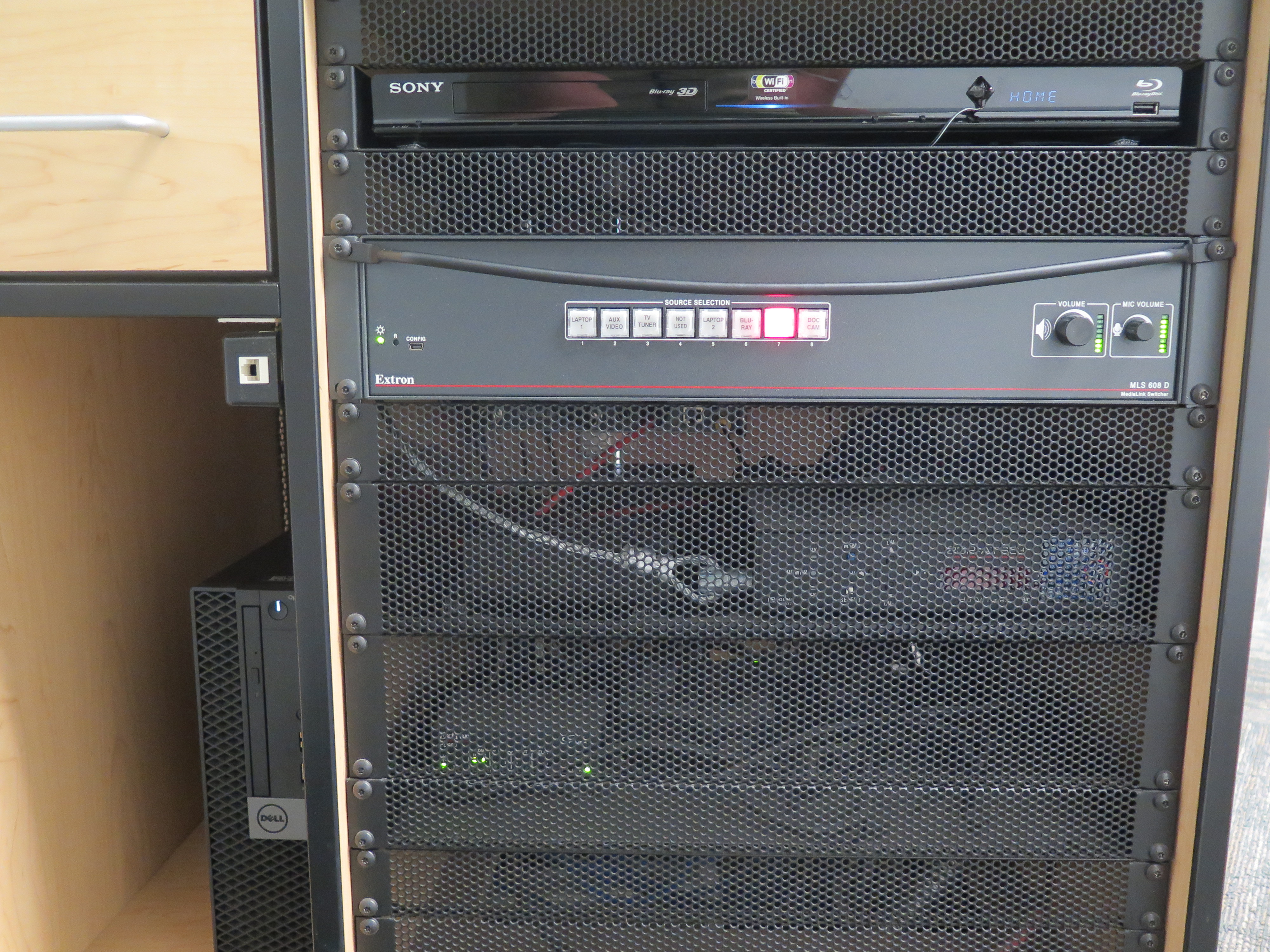 front of equipment rack showing AV switcher, below that is blue-ray/dvd player, below that is the dell computer CPU