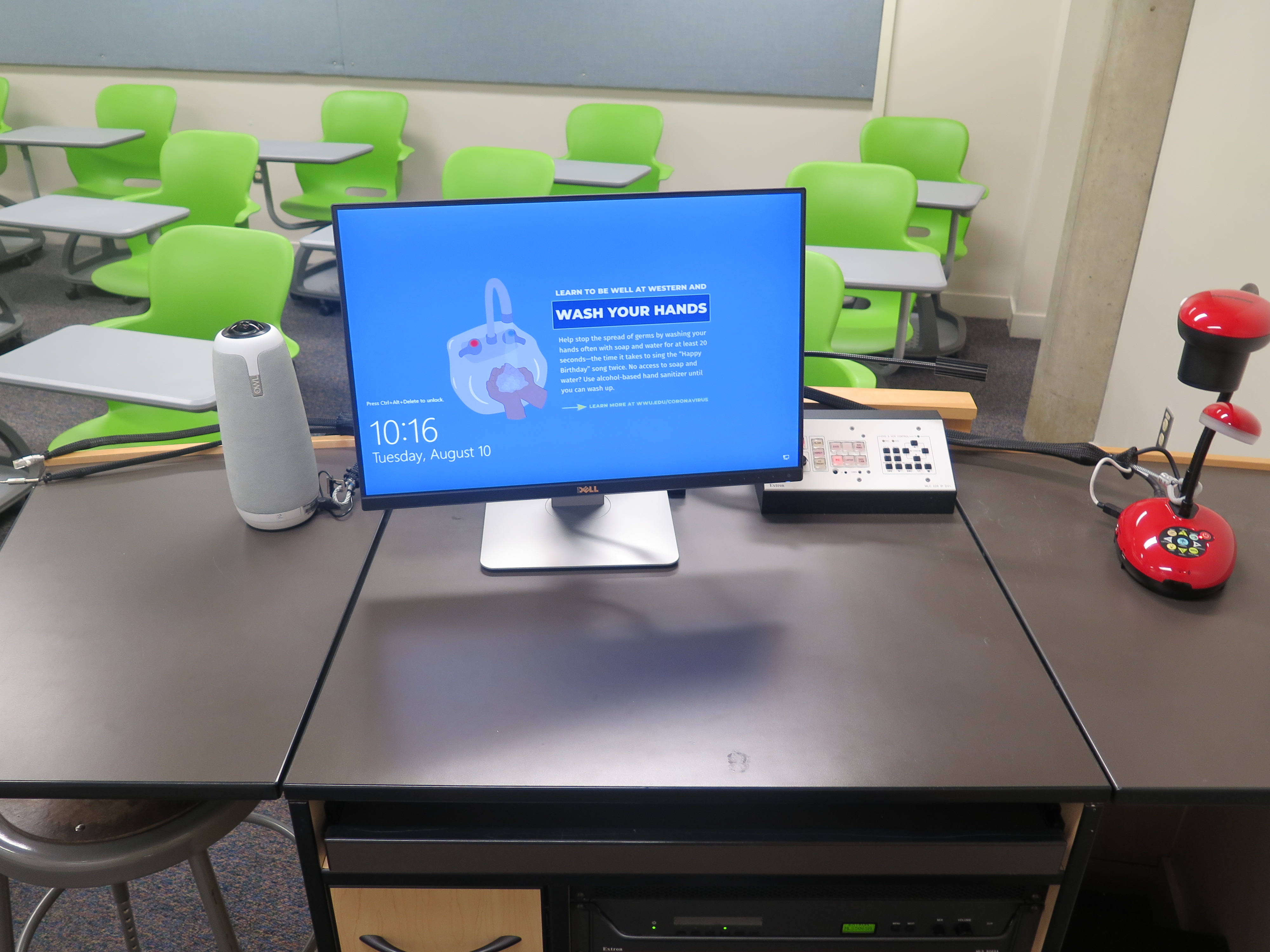 on top of podium is owlcam, dell computer monitor, AV push button controller, and lumins ladybug document camera