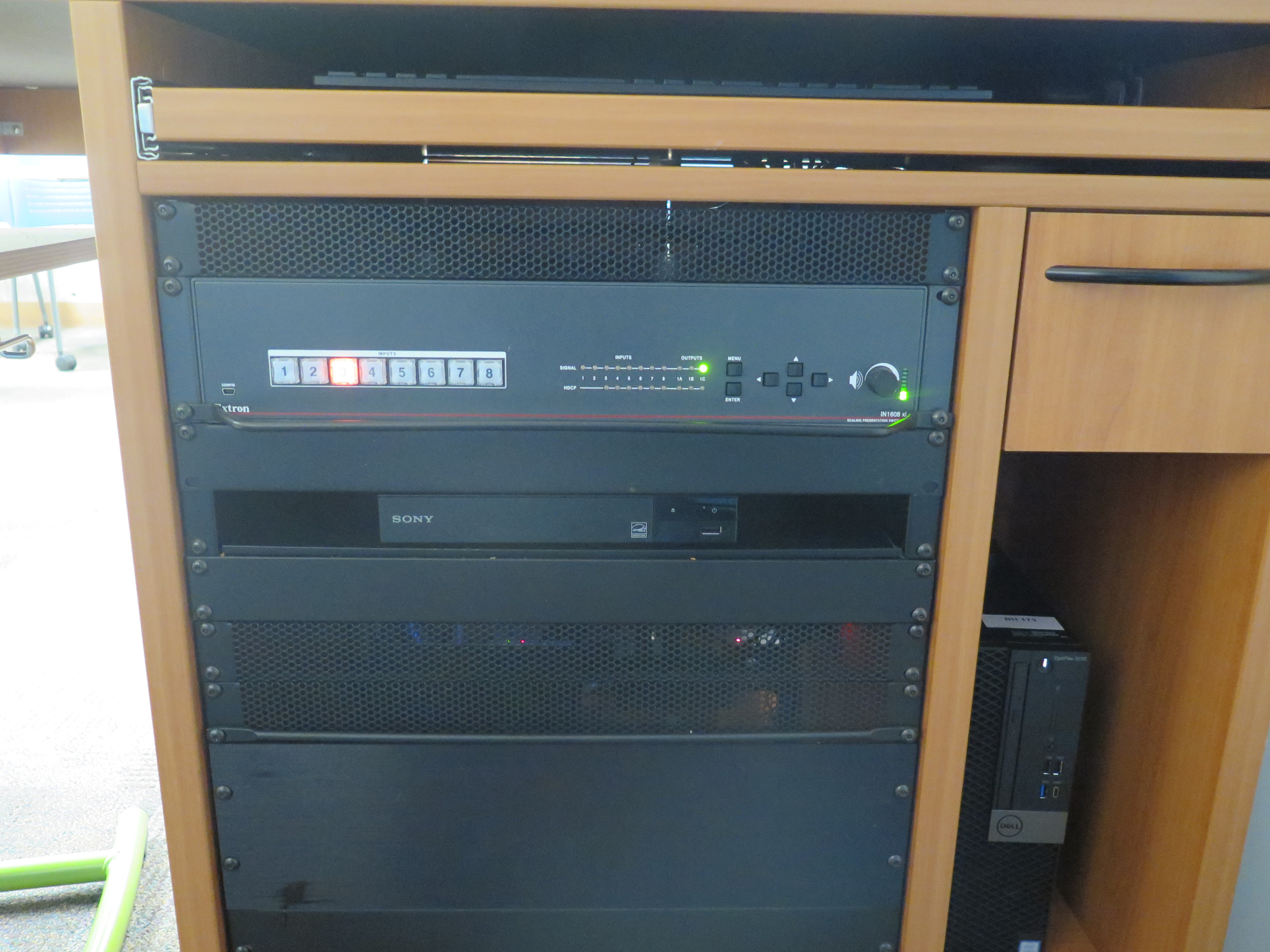 Front of Equipment rack showing AV Switcher. Below that is the DVD Player. To the right is the compartment with the Dell Computer CPU.