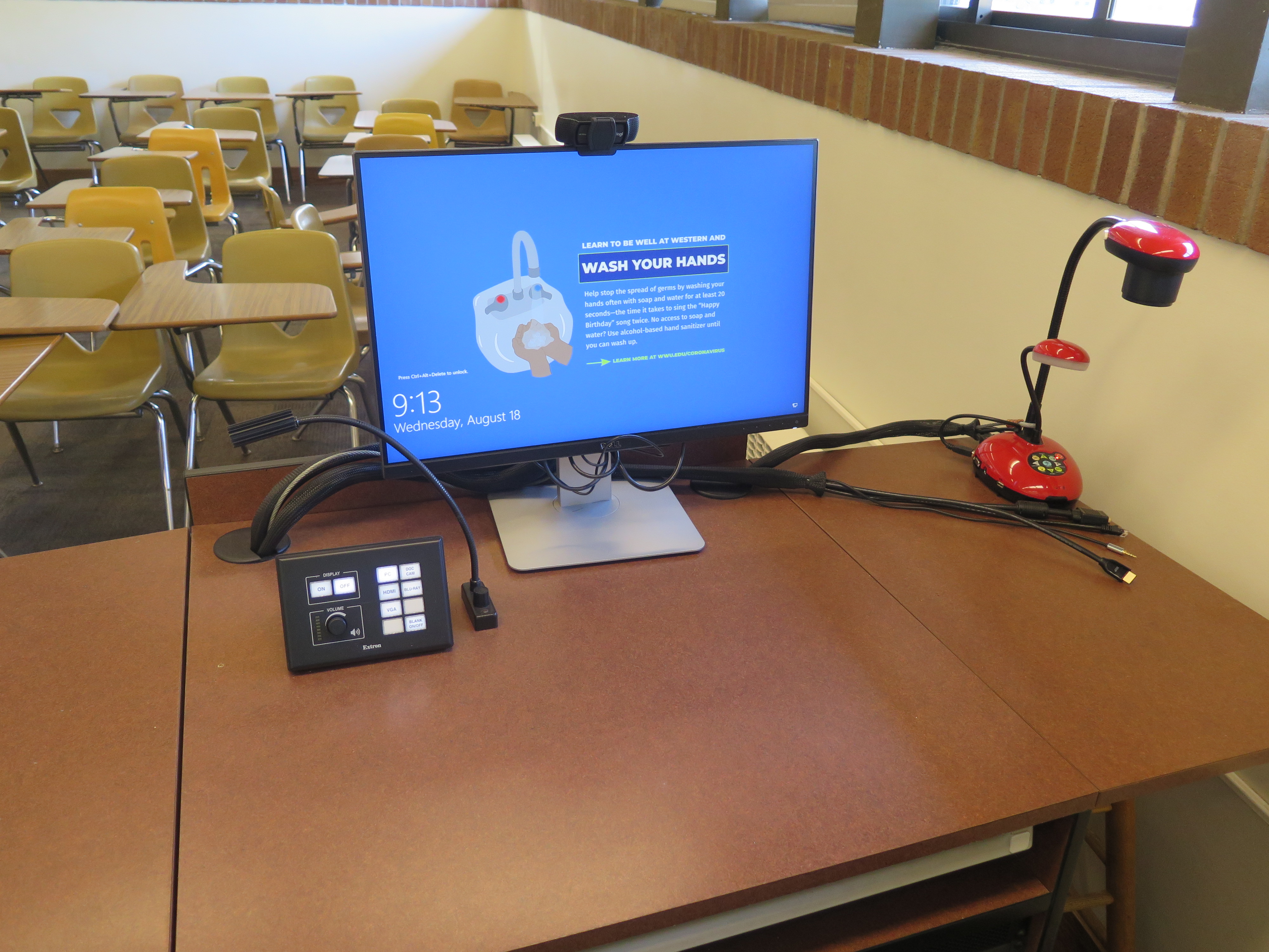 Top of the podium has a Ladybug document camera, Dell PC Monitor, AV push button Switcher, and a Logitech Webcam