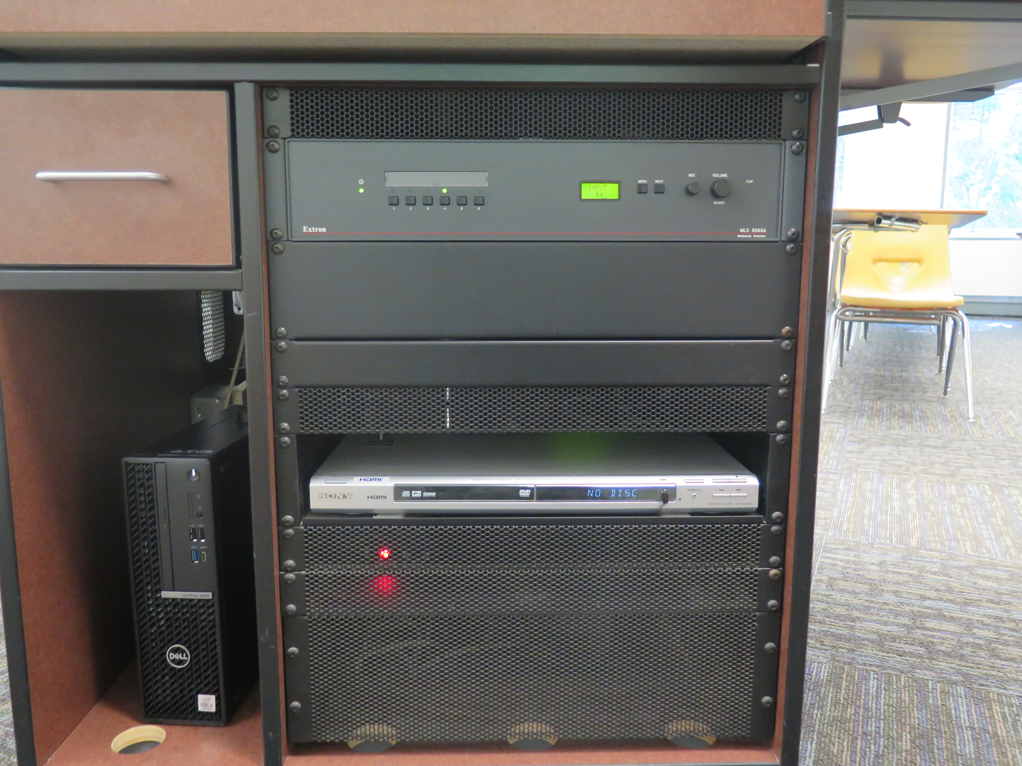 Front of Equipment rack showing AV Switcher. Below that is DVD Player. To the left is the compartment with the Dell Computer CPU.