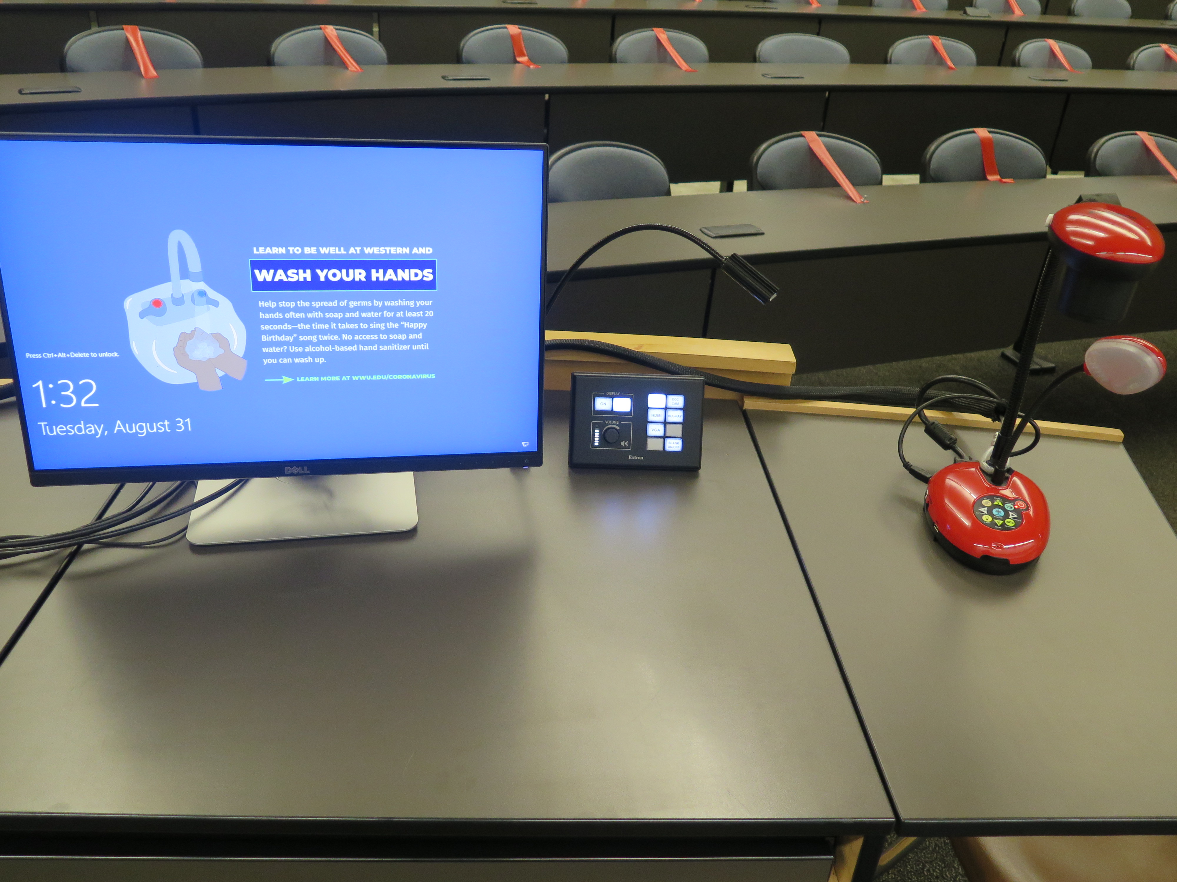 top of podium showing monitor, AV controller and Lumens Ladybug document camera.