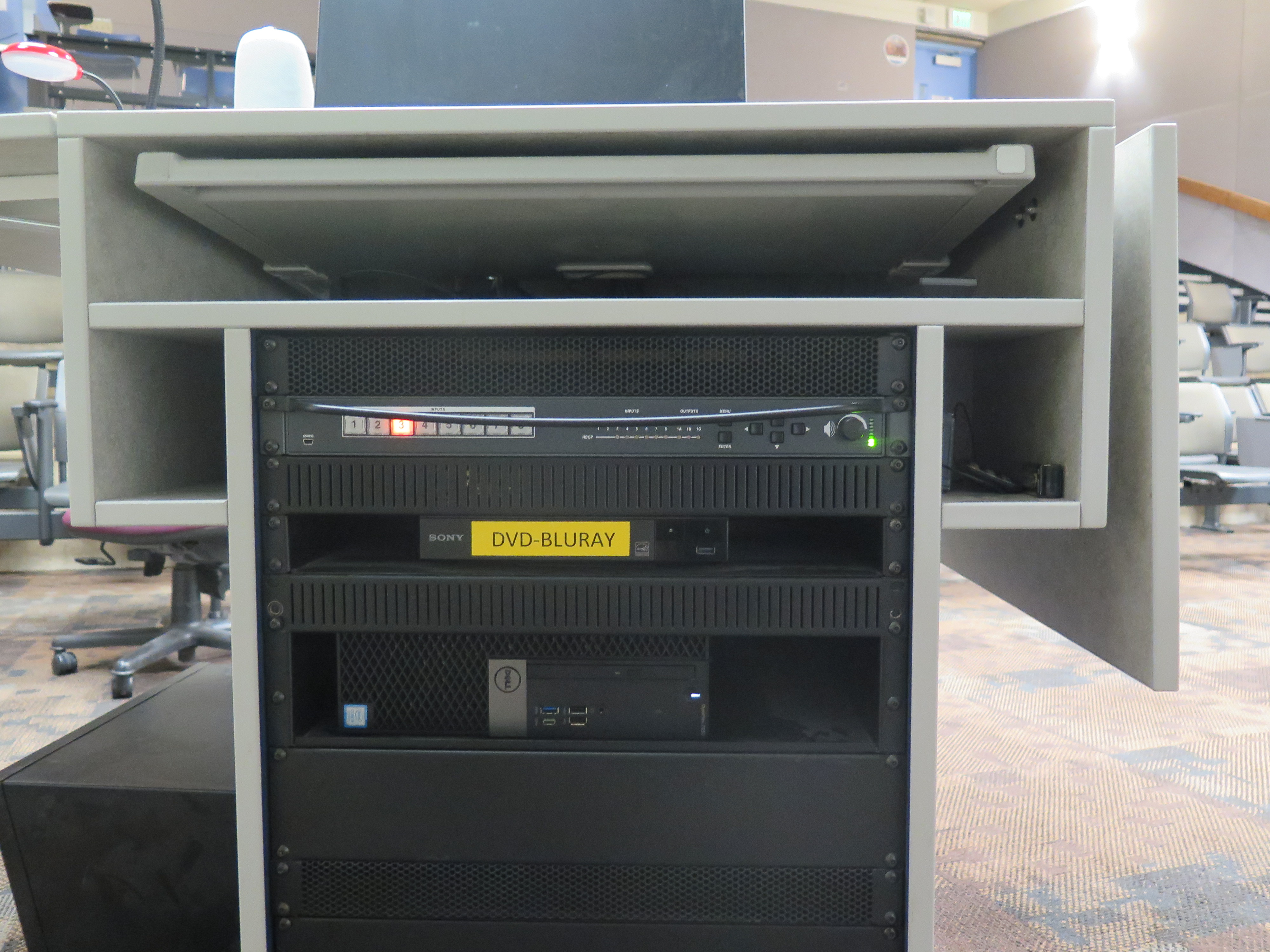 Equipment rack consists of AV Switcher, Blu-Ray/DVD Player and Dell Computer CPU.