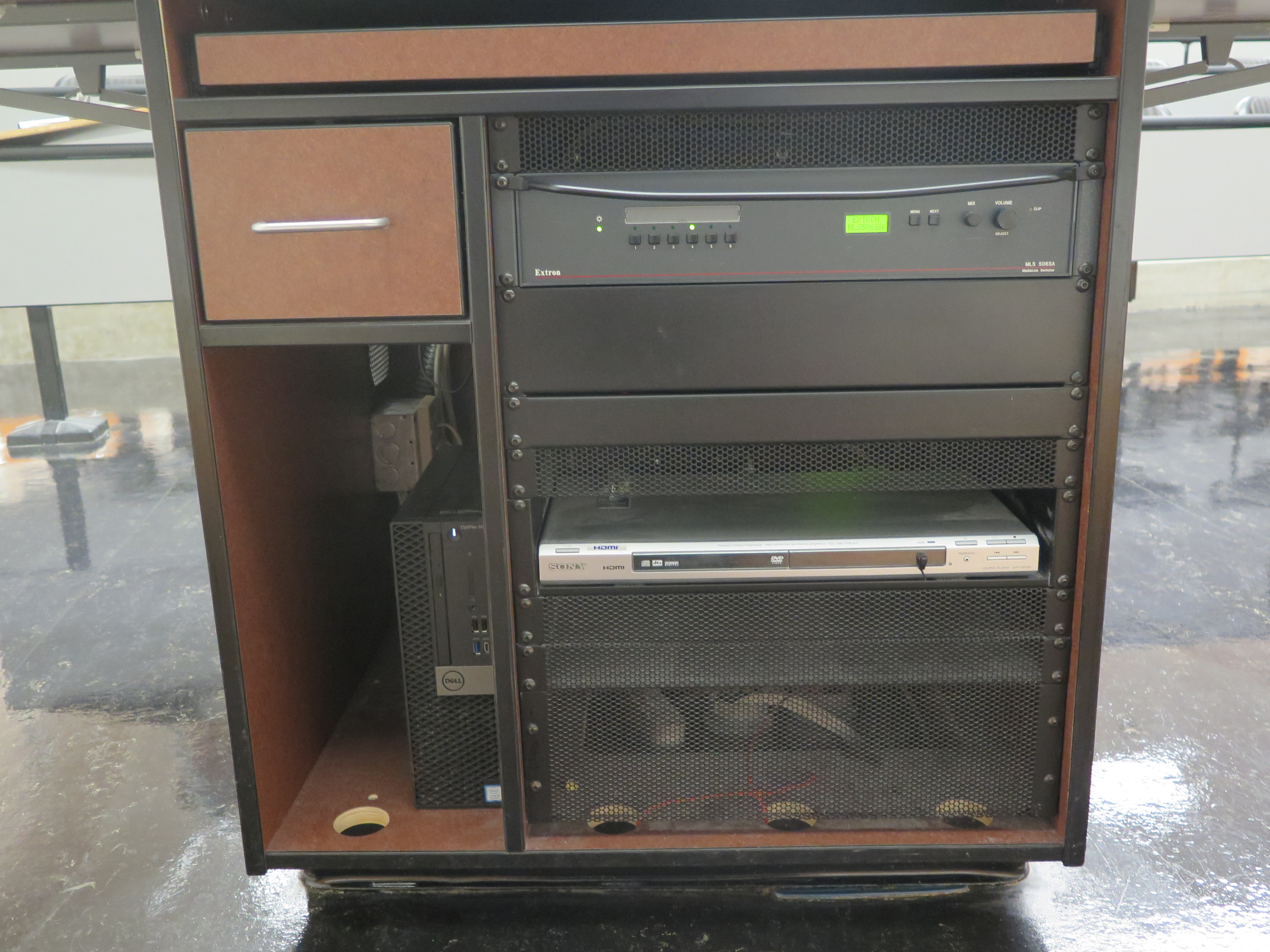 Front of Equipment rack showing AV Switcher. Below that is a DVD Player. To the left is the compartment with the Dell Computer CPU.