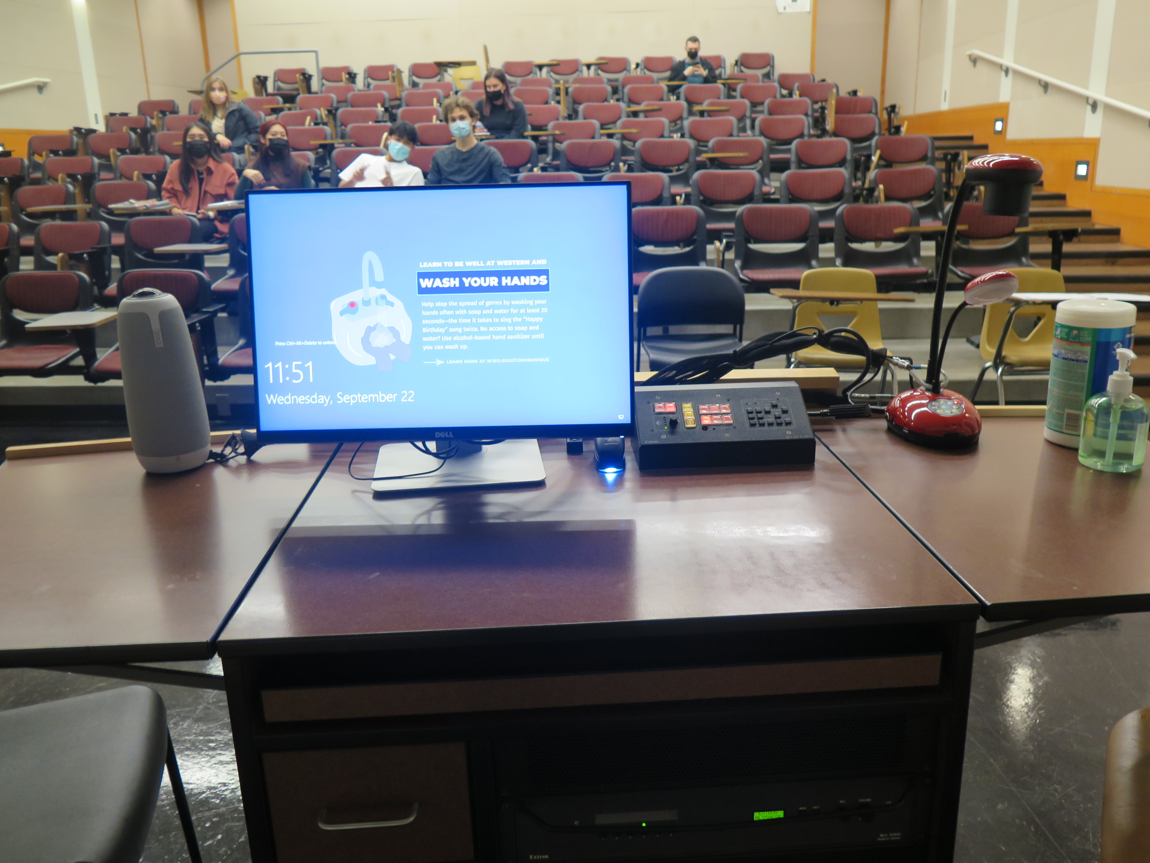On top of Podium is Owl webcam, Dell Computer Monitor, AV Push Button Controller, and a Lumens Ladybug Document Camera.