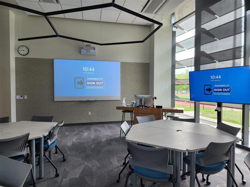 view of room showing both the flatscreen TVs and the main projector