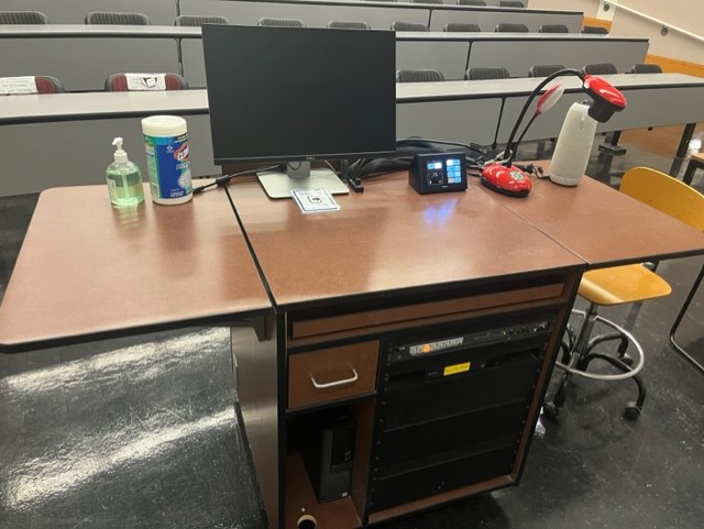 Top of teaching podium showing Document camera, control box, Owl camera, keyboard, mouse, computer monitor